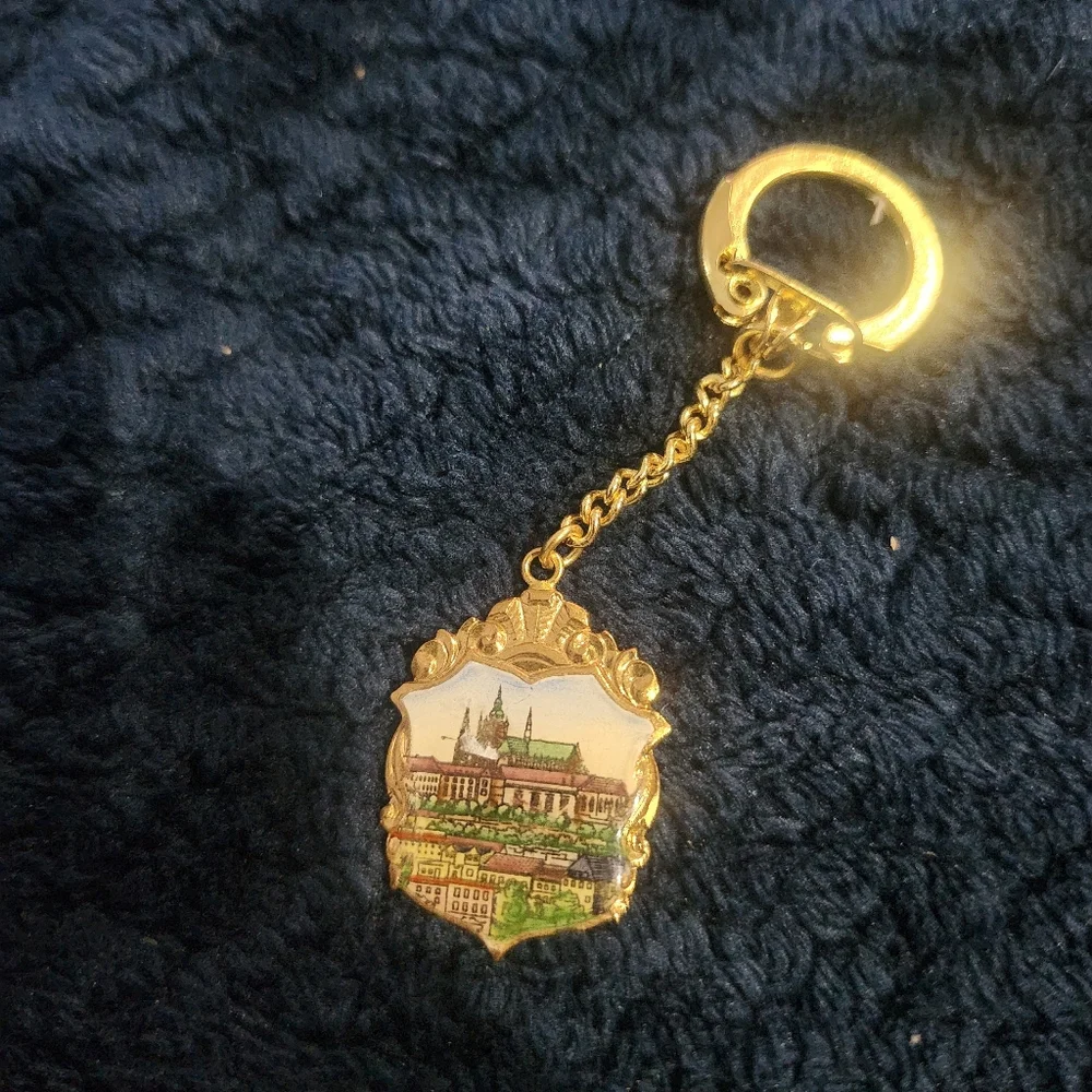 Vintage souvenir keychain a painted enamel depiction of Prague Castle